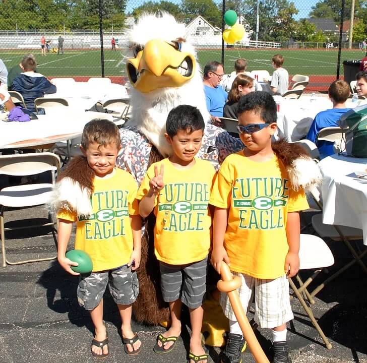 three members of the future eagles club with the st edward eagle mascot