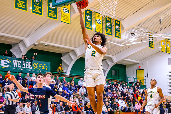 st edward varsity basketball player drives in for a shot during a basketball game