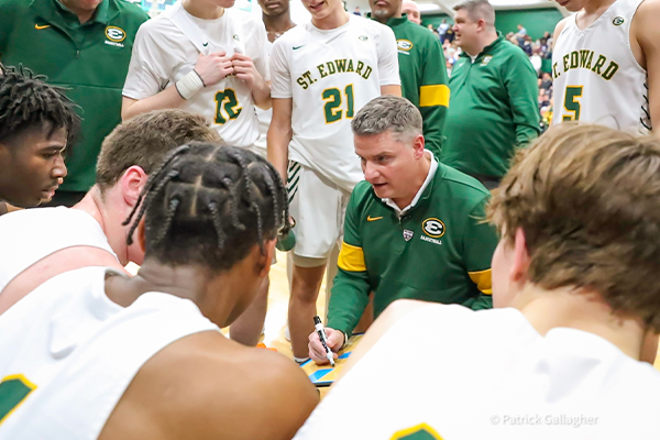 st edward varsity basketball head coach eric flannery with his team during a timeout