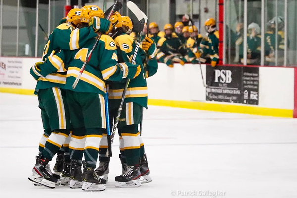 st. edward high school hockey players after winning a game