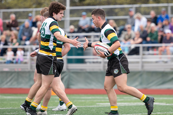 three st. edward high school rugby players after scoring
