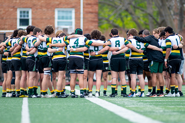 the st edward high school rugby team in a huddle