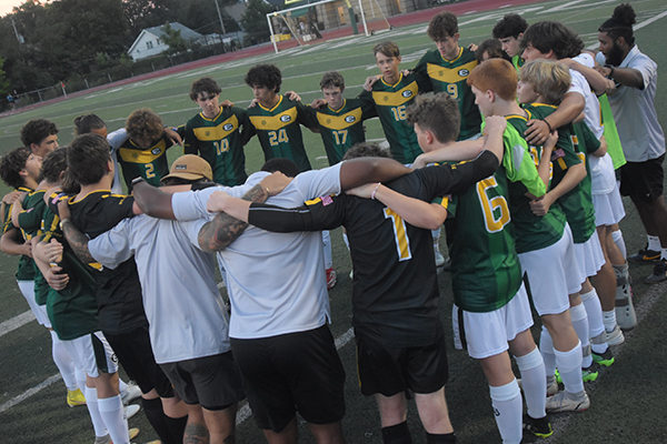 st edward junior varsity gold soccer players in a huddle