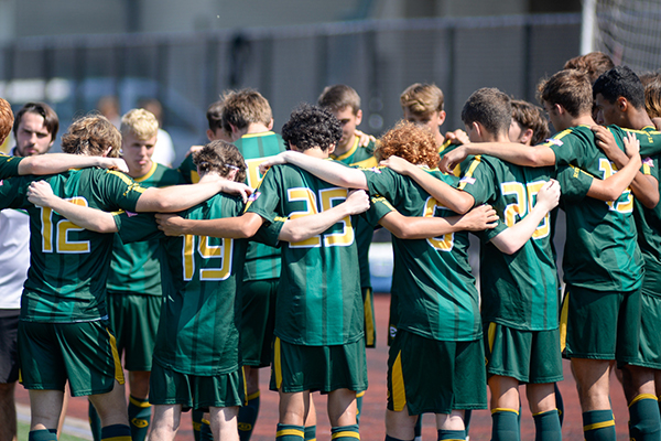 st edward junior varsity green soccer players in a huddle