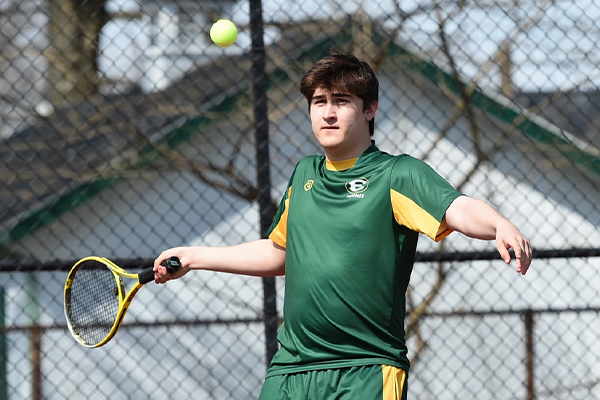 st edward high school tennis player returning the ball