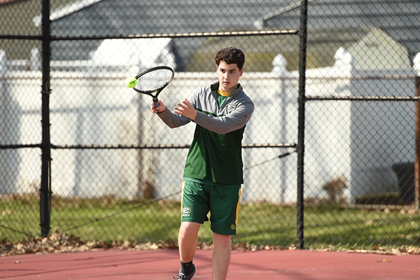 st edward high school tennis player hitting the ball