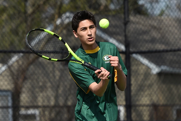 st edward high school tennis player hitting the ball