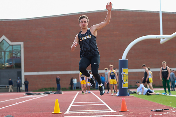 st. edward track and field athlete doing the long jump