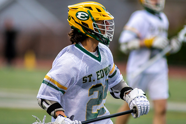 st. edward high school varsity lacrosse player running during a game