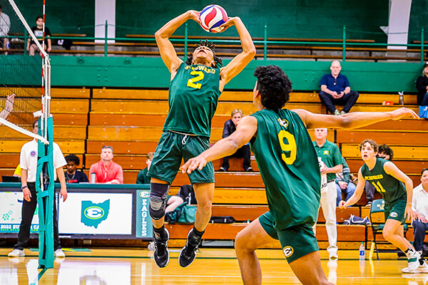 st. edward high school volleyball players returning the ball