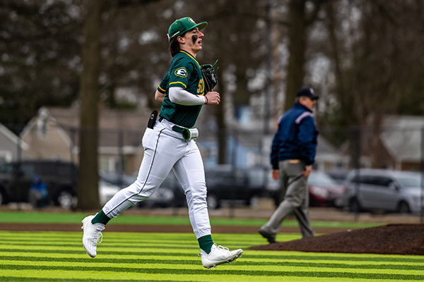 st edward high school baseball player returning to the dugout after three outs