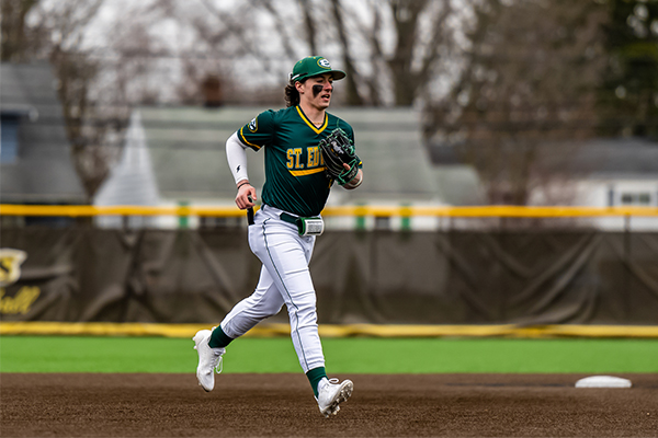 st edward high school baseball player returning to the dugout after three outs