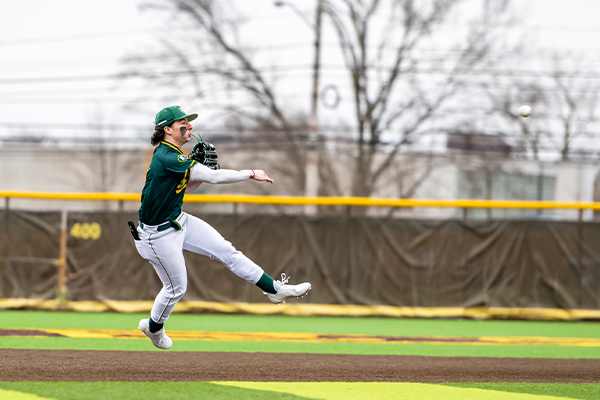 st edward high school baseball player throws the ball to get an out
