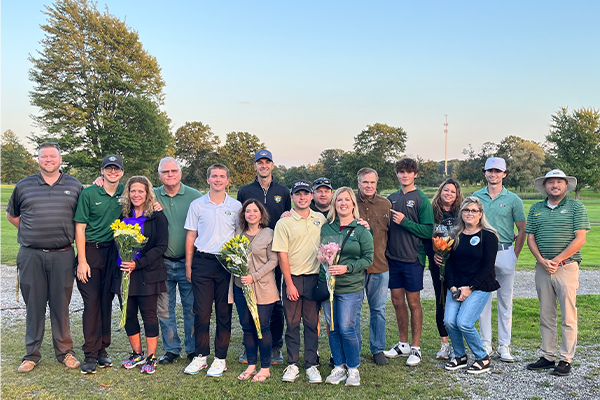 seniors on the varsity golf team celebrating senior night with their parents