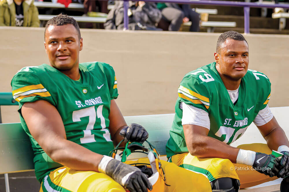 deontae and devontae armstrong on the bench during a varsity football game