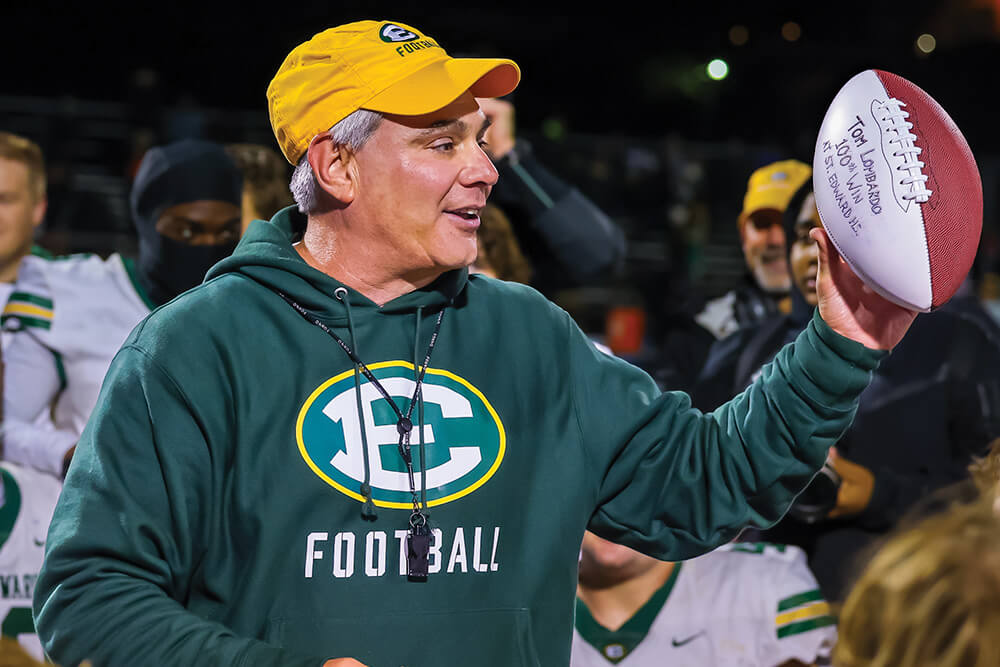 tom lombardo addresses the varsity football team after his 100th win at st edward high school