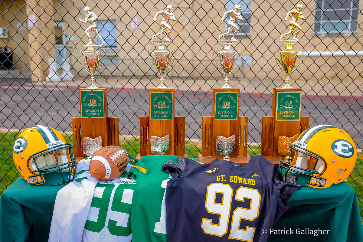 the 2010, 2014, 2015, and 2018 football state championship trophies