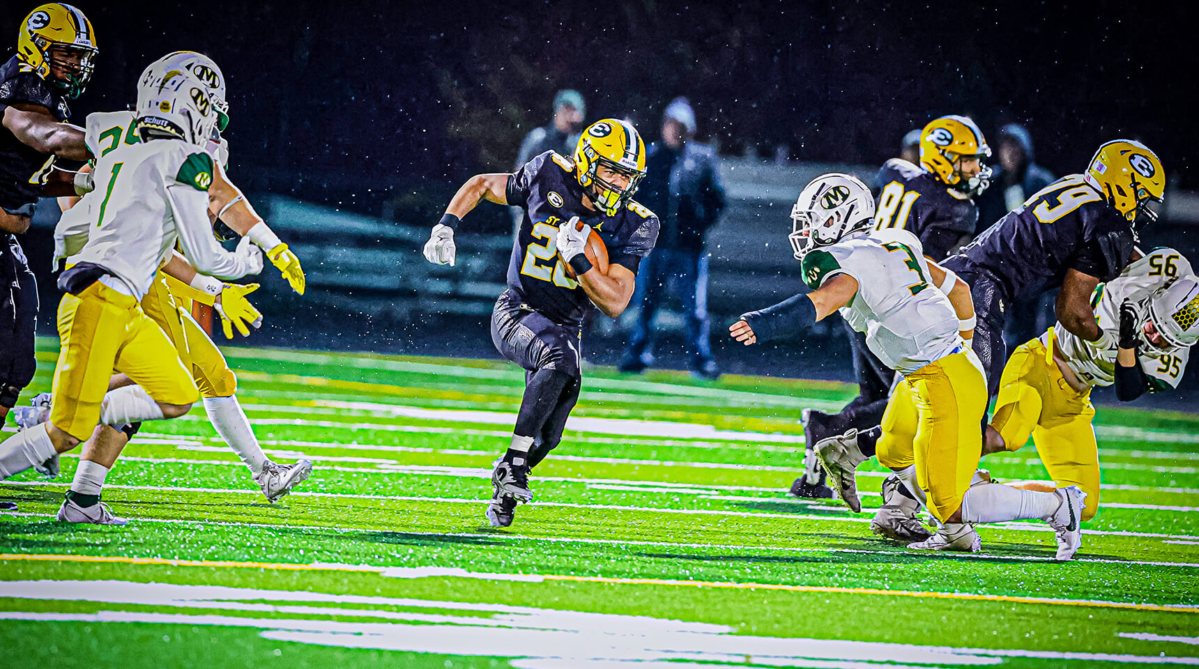 varsity football star brandon white runs with the ball in the team's game against Medina