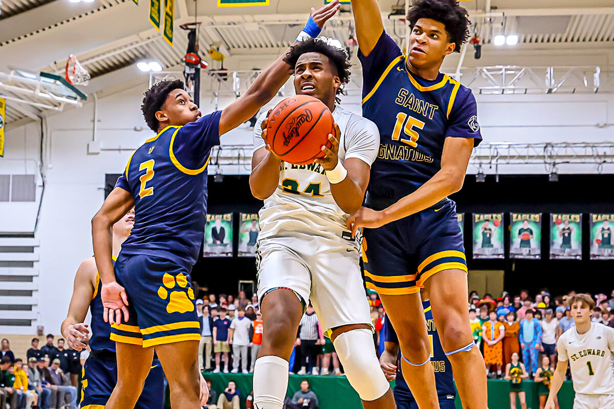 varsity basketball player taking a shot during a game