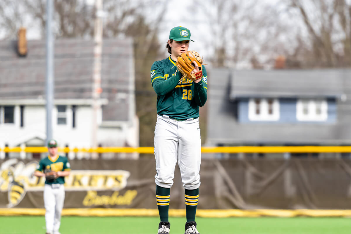 varsity baseball pitcher at the mound during a game against brunswick