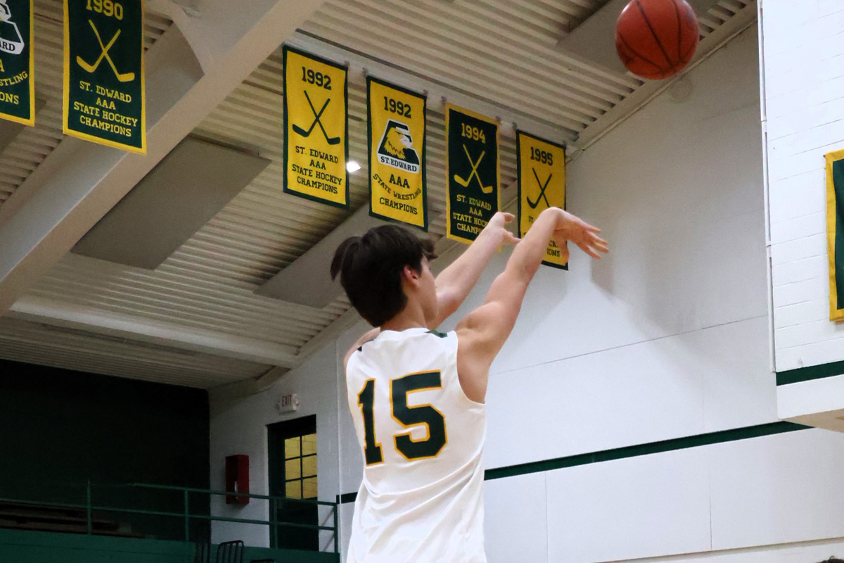 st. edward varsity green basketball player taking a shot