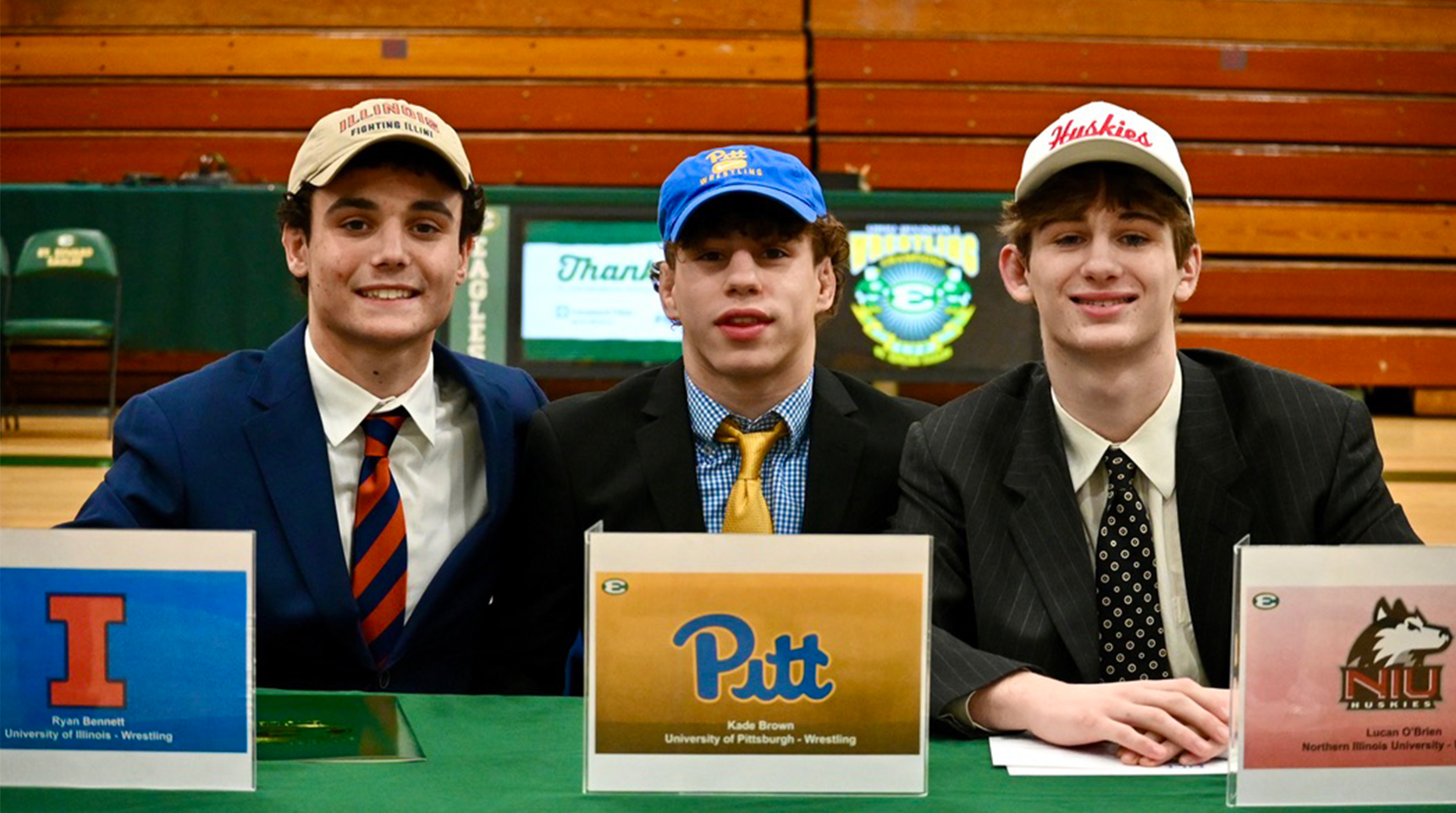 three class of 2024 wrestlers pose during national signing day
