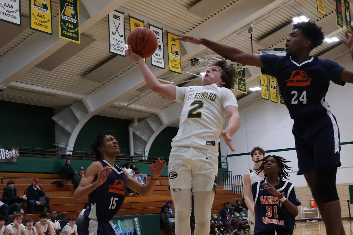 freshman gold basketball player going for a layup