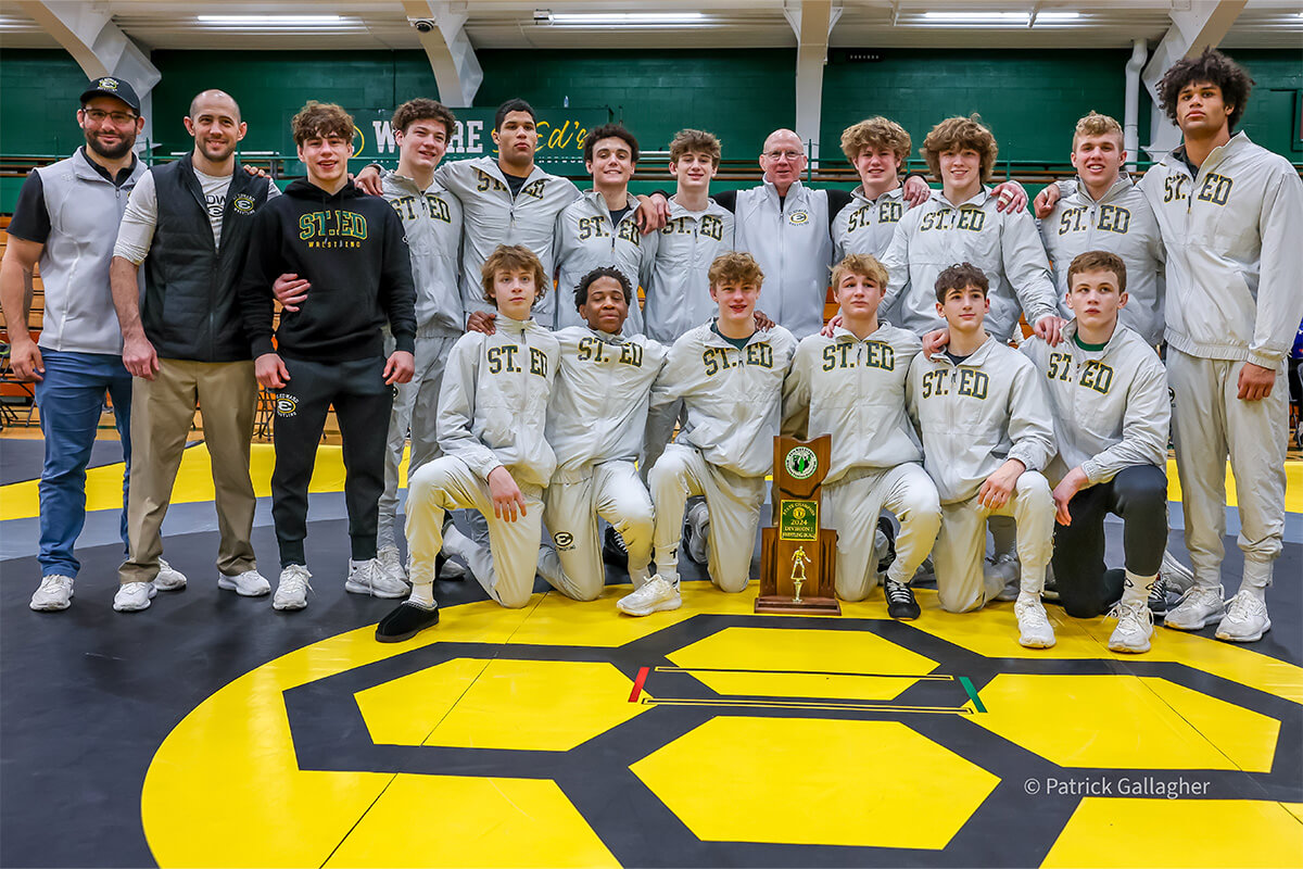 members of the varsity gold wrestling team celebrate after winning the 2024 duals state championship