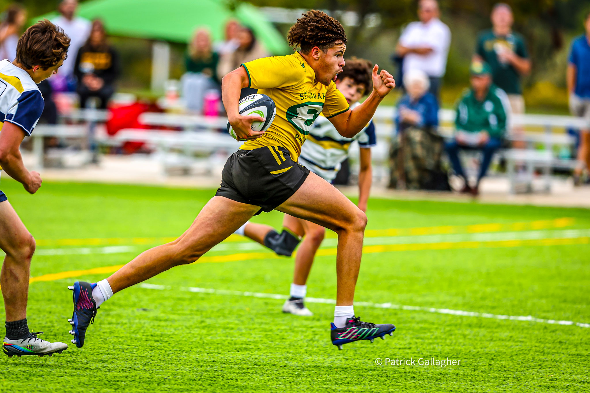 varsity gold rugby player scoring during a match in 2023