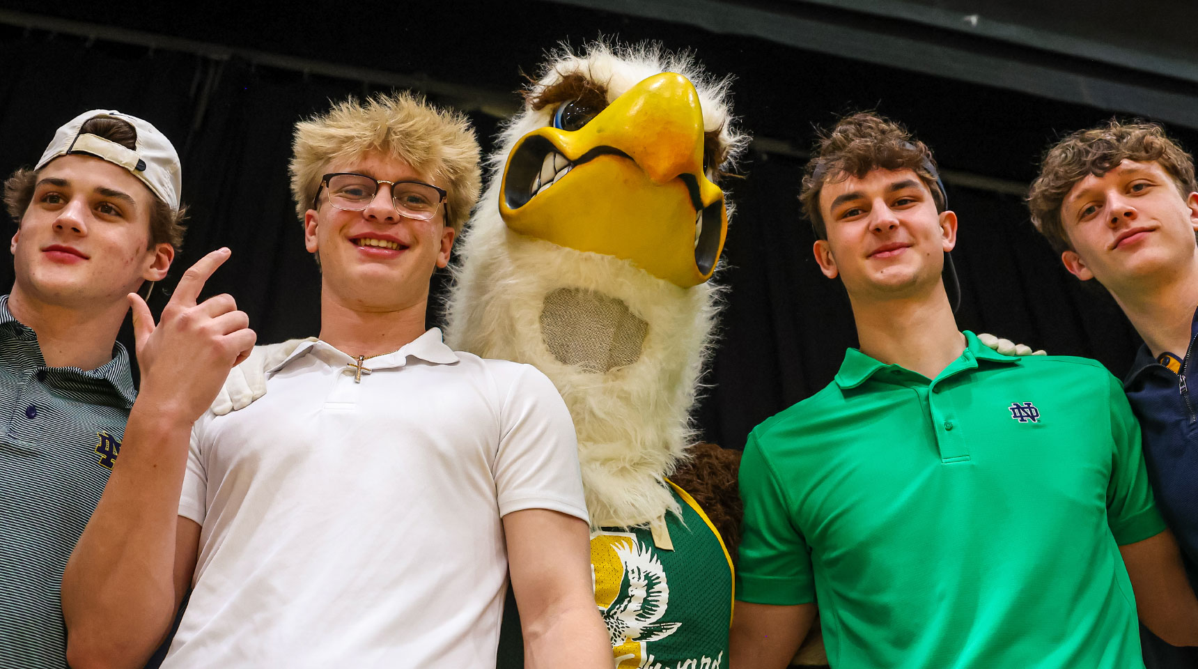 st. edward students pose with eagleman in the student section during a basketball game